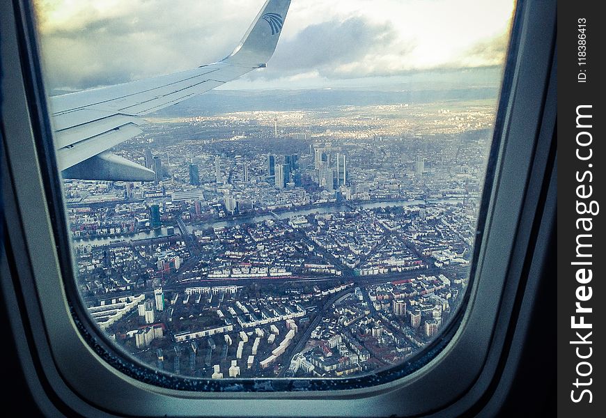 Airplane Windowpane Showing City Buildings