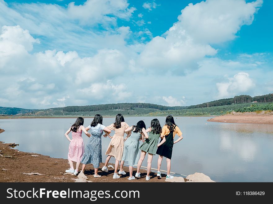 Six Women Standing Near Body of Water