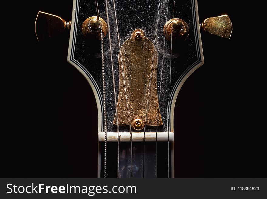 Details of an old dusty electric guitar.