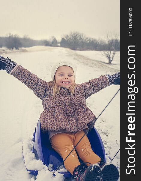 Portrait of little girl at winter season. Moving activity. Close up image.