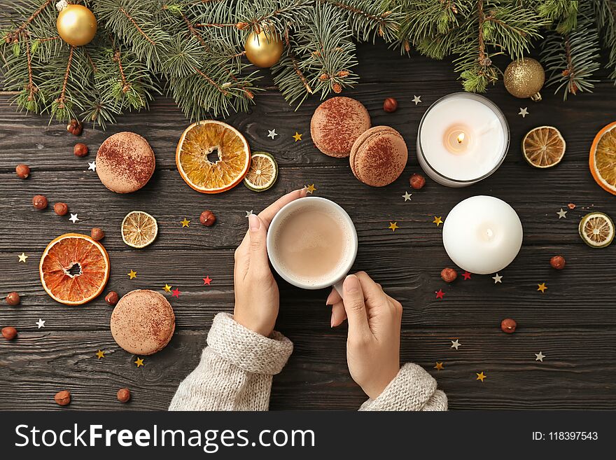 Woman with hot cocoa drink at table, top view