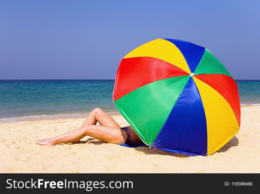A slender white girl sunbathing on the ocean.