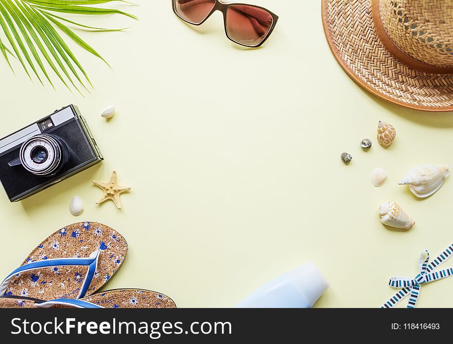 Traveler accessories on yellow background with copy-space
