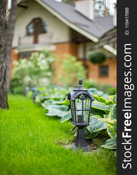 Garden lantern on the green grass. landscape design. Garden lantern on the green grass. landscape design