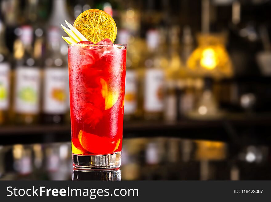 Closeup Glass Of Cocktail With Strawberry Syrup, Rum And Lemon