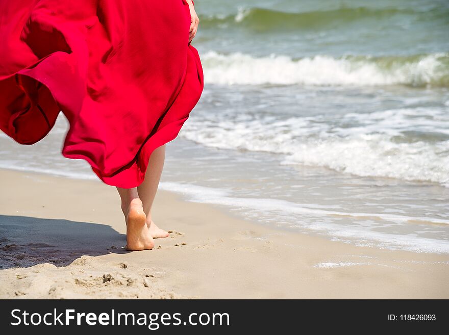 Woman walking on sand beach leaving footprints in the sand. Woman walking on sand beach leaving footprints in the sand