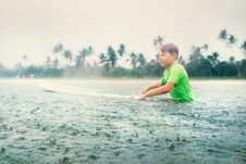 Boy First Step Surfer Learning To Surf Under The Rain Royalty Free Stock Photo