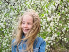 Portrait Of A Beautiful Girl In A Denim Shirt Next To A Cherry Tree. Portrait Of Laughing Happy Girl. Royalty Free Stock Image Portrait Of A Beautiful Girl In A Denim Shirt Next To A Cherry Tree. Portrait Of Laughing Happy Girl. Royalty Free Stock Image