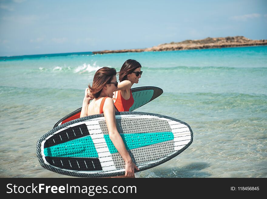 Attractive cheerful women are spending time on beach