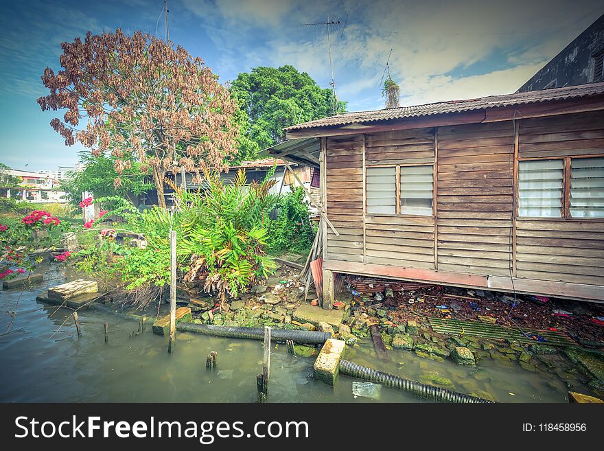 Vintage tone close-up old shack slum house near Malacca river. Old wooden hut on stiltson the bank of river in Melaka. Vintage tone close-up old shack slum house near Malacca river. Old wooden hut on stiltson the bank of river in Melaka