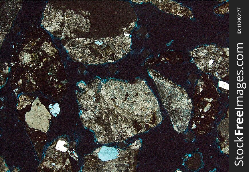 Fragment of rock observed with two light filters, under a polarizing microscope. Fragment of rock observed with two light filters, under a polarizing microscope.