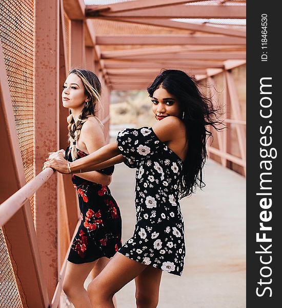 Photography of Two Women on Bridge
