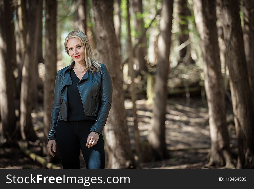 Woman Wearing Black Leather Jacket in Forest