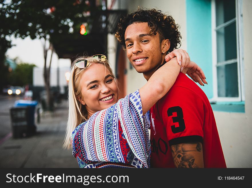 Close-Up Photo of Woman Hugging a Guy