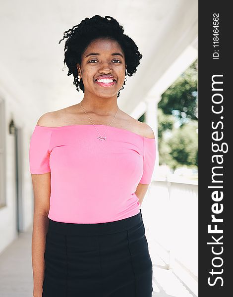 Smiling Woman Wearing Pink Off-shoulder Short-sleeved Blouse and Black Skirt Selective Focal Photo