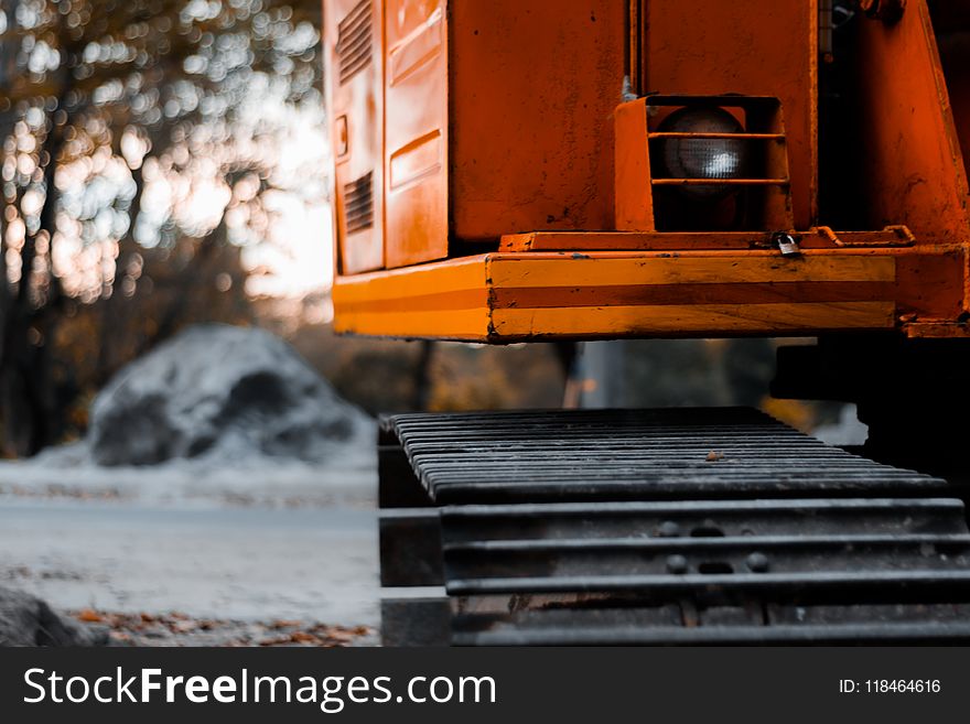 Black and Red Heavy Equipment Near Gray Rock