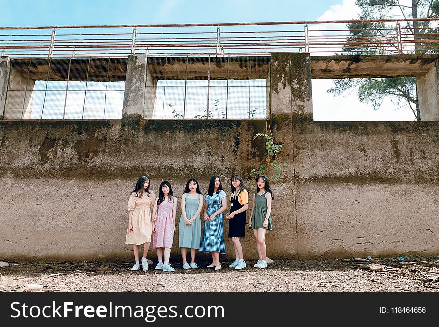 Six Women Standing Near Wall