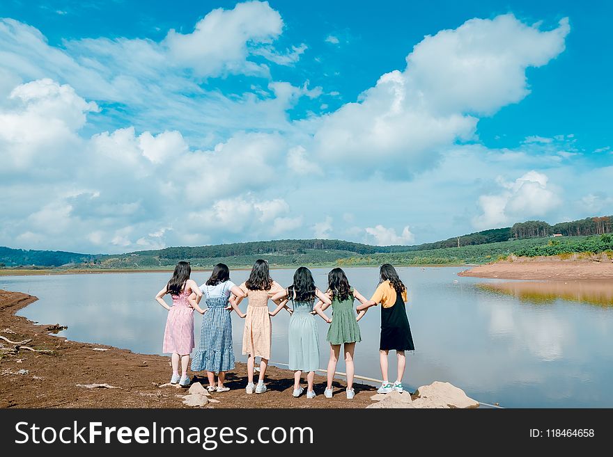 Group of Girls Standing Beside River