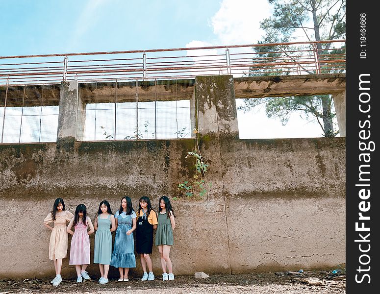 Group Of Women Standing Infront Of Wall