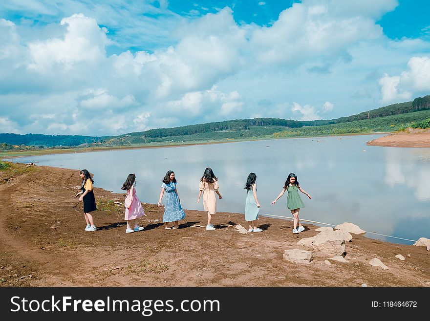 Six Girl Standing Beside Body of Water