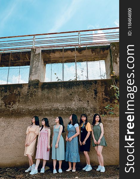 Six Women Stands in Front of Gray Concrete Wall