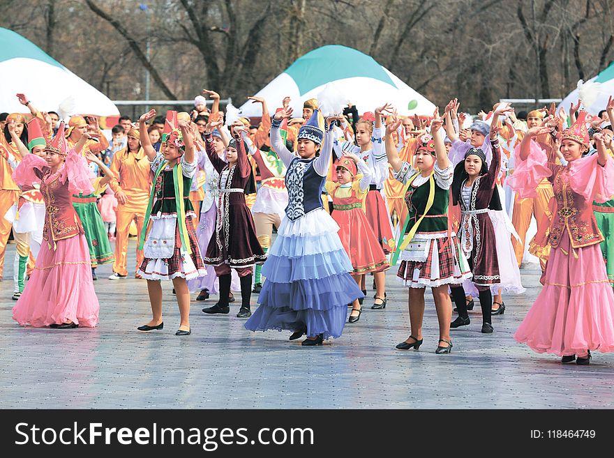 Women and Girls Wearing Traditional Dresses Holding Up Two Hands