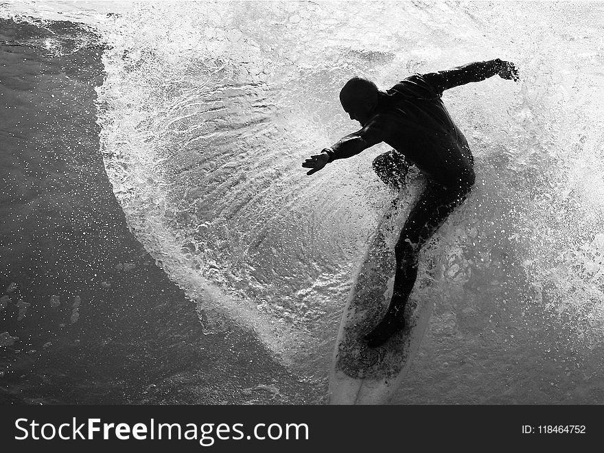 Grayscale Photo Of Man On Surfboard