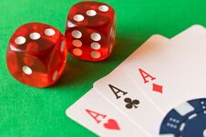 Dice, Poker Chips And Playing Cards On The Green Table . The Con Stock Photo