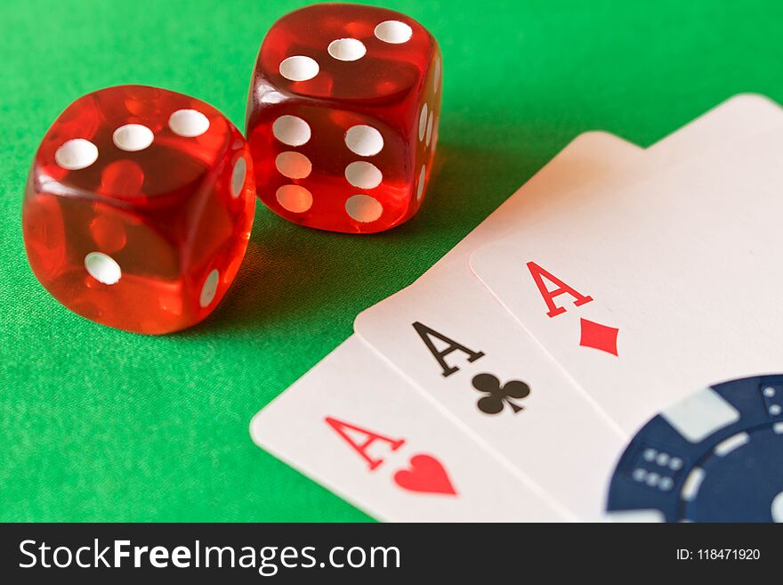 Dice, poker chips and playing cards on the green table . The concept of winning. Close up.