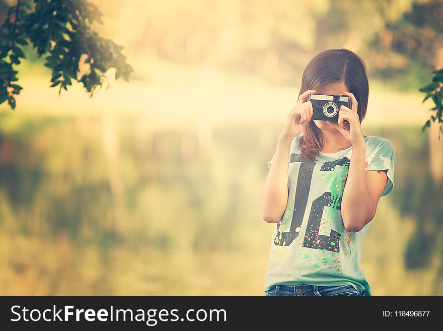 Pretty photographer girl with vintage camera.