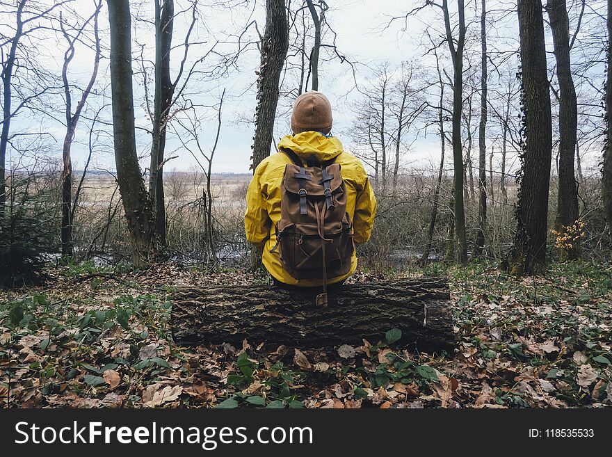 Man with backpack in wild forest. Travel and adventure concept. Landscape photography