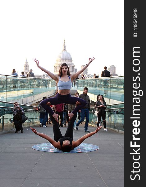 Two Women Performing Yoga on Street at Daytime