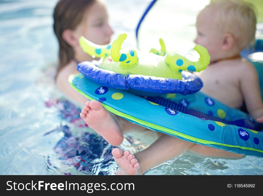 Baby on Blue and Green Personal Flotation Device