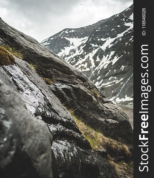 Rocky Mountain With Green Grasses At Daytime