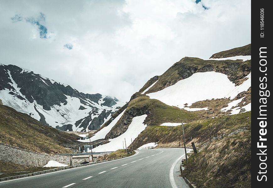 Scenic View Of Mountains Under Cloudy Sky