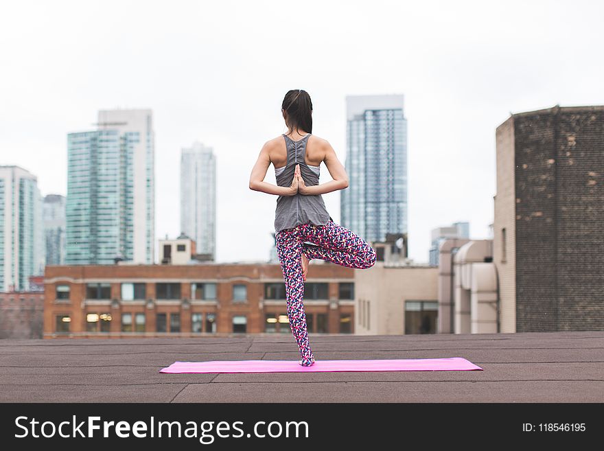 Woman Standing on Pink Yoga Mat Meditating