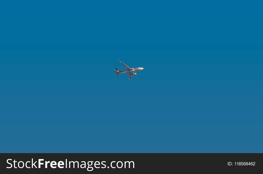 An airplane in a beautiful sunny day of winters and vibrant blue sky in background. An airplane in a beautiful sunny day of winters and vibrant blue sky in background.