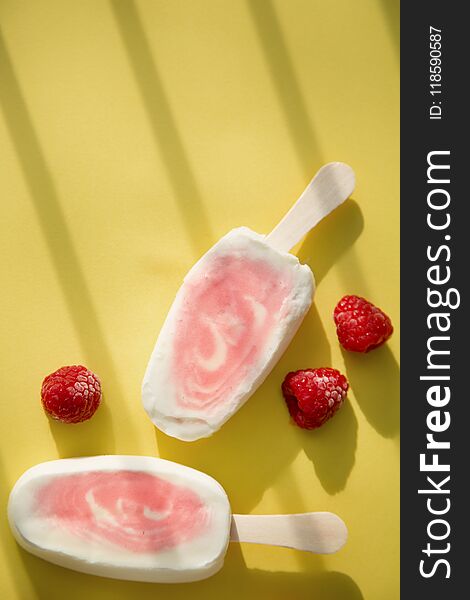 Popsicle with fresh raspberry on a table