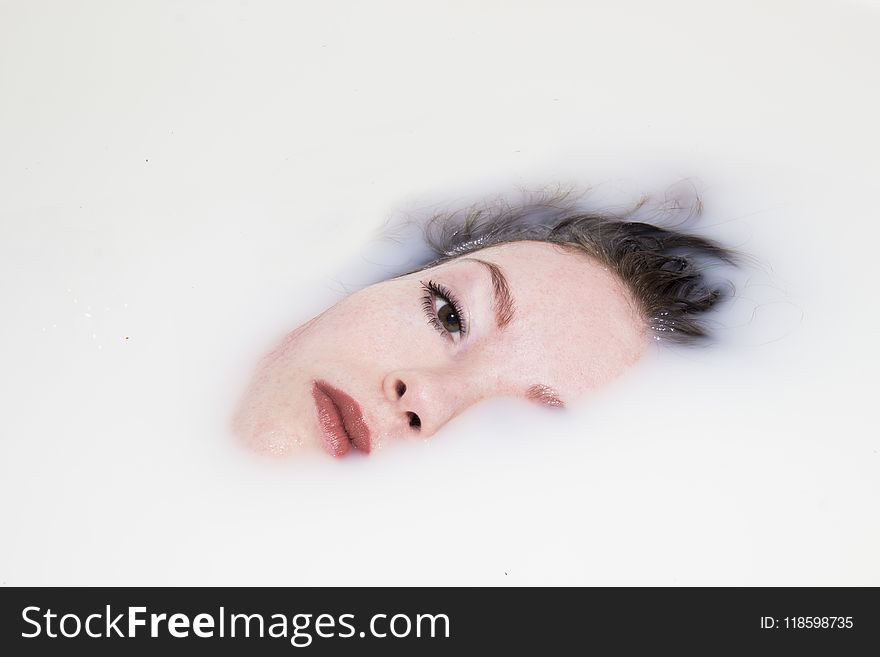 Woman&x27;s Face On White Liquid