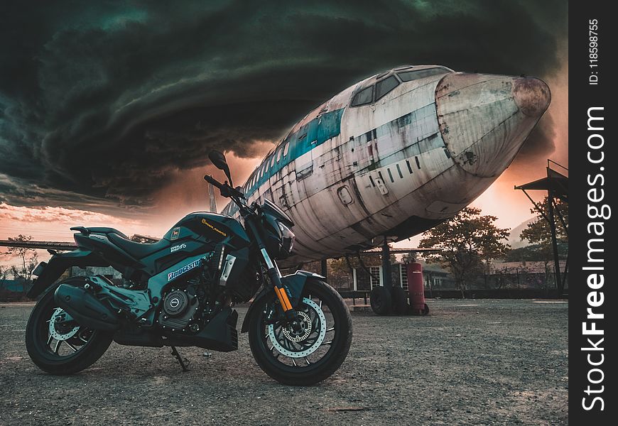 Photo of Motorcycle Near Airplane