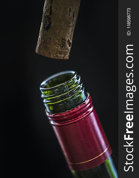 Closeup Photo of Green Glass Bottle and Cork
