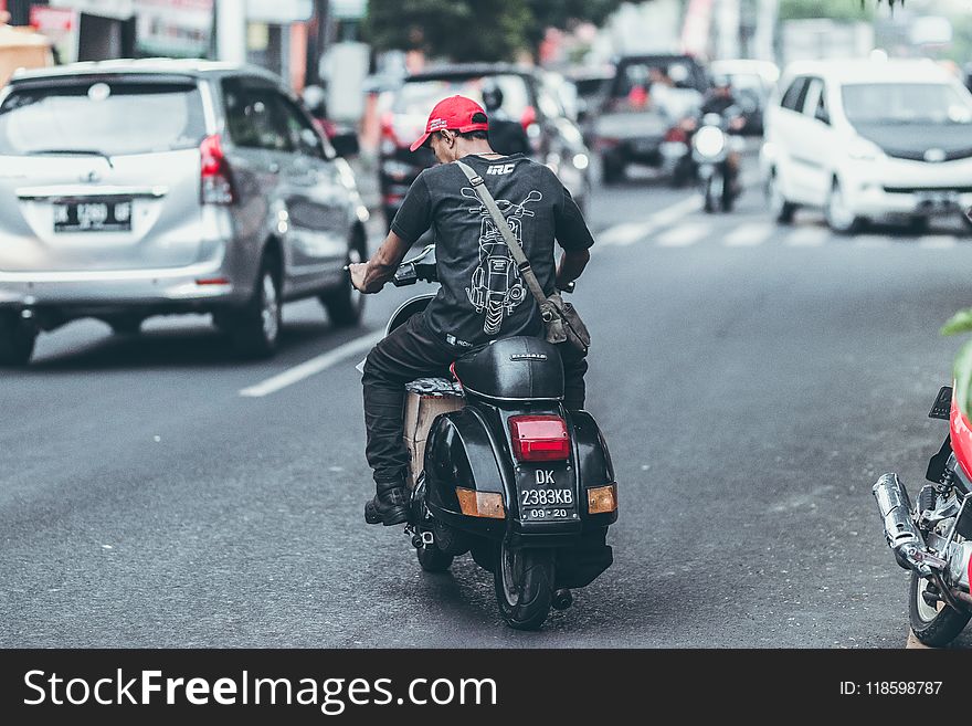 Photo of Man Riding Motorcycle on the Road