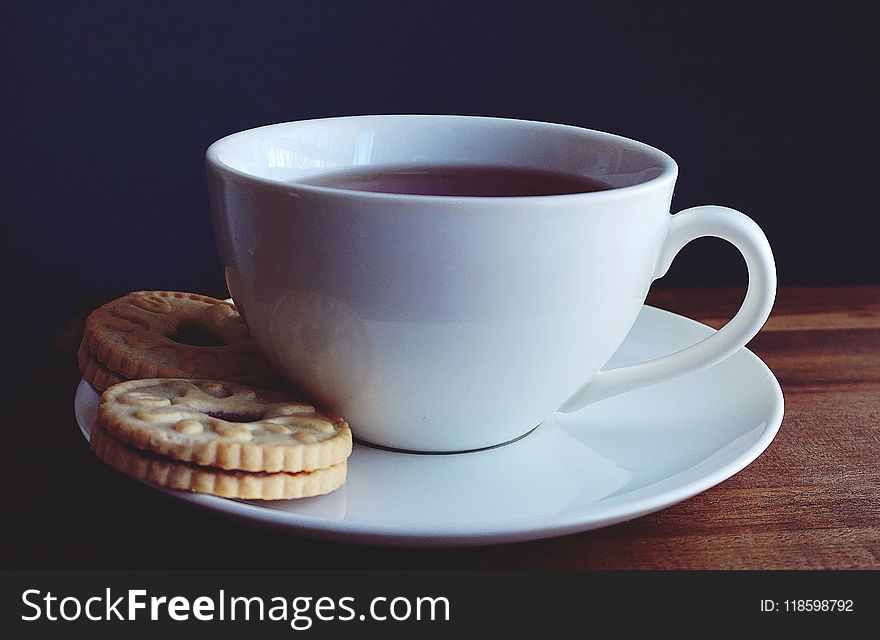 Close-up Photography of Cup of Coffee Near Biscuits