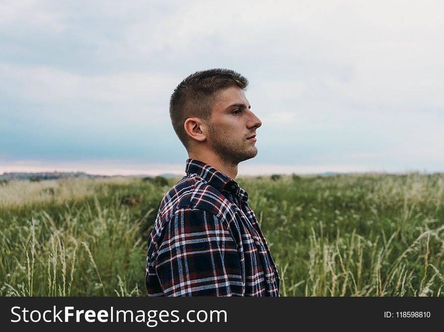 Man Standing on Grass Field