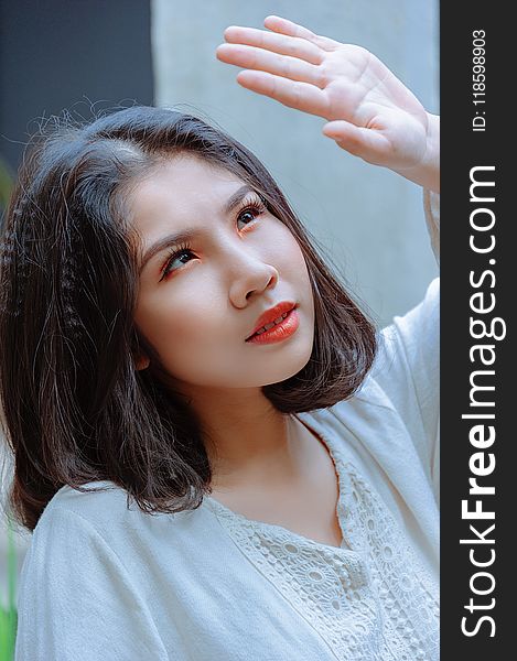 Shallow Focus Photography Of Woman In White Top