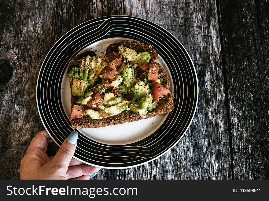 Person Holding Plate With Food