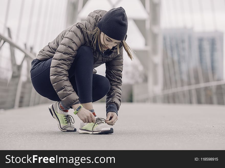 Photo of Woman Tying Her Shoe
