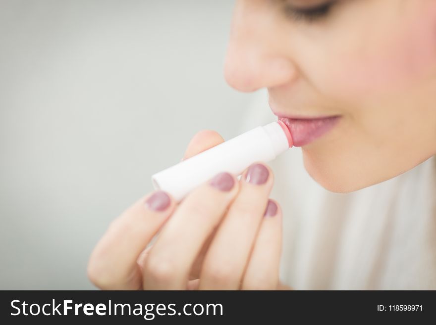 Woman Putting Lipstick