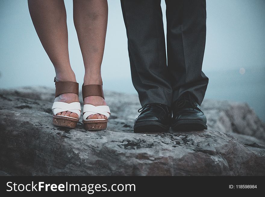 Closeup Photo of Two Person&#x27;s Legs