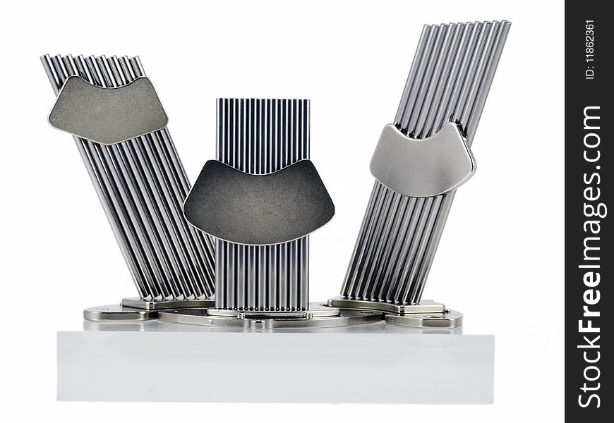 The chromeplated polished metal sticks are fastened together by super magnets from hard disks. The design is similar to a monument. Isolated on white. The chromeplated polished metal sticks are fastened together by super magnets from hard disks. The design is similar to a monument. Isolated on white.